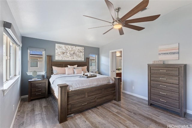 bedroom with ensuite bath, ceiling fan, wood-type flooring, and lofted ceiling