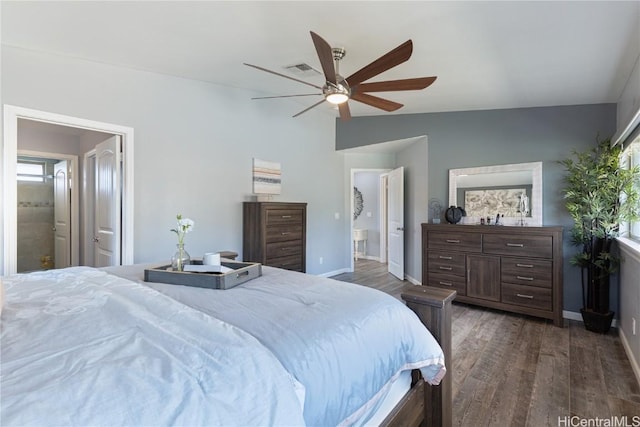 bedroom with ensuite bath, ceiling fan, dark hardwood / wood-style floors, lofted ceiling, and multiple windows