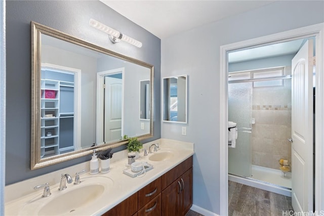 bathroom featuring vanity, wood-type flooring, and an enclosed shower