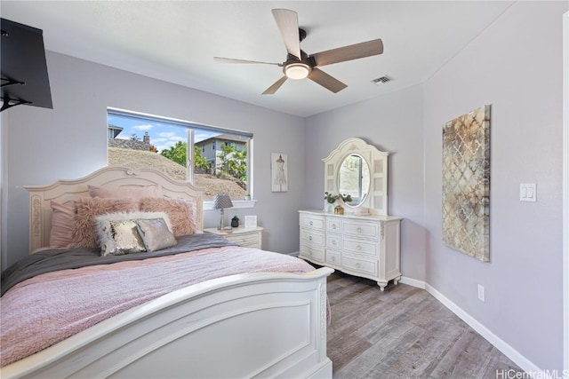 bedroom with hardwood / wood-style floors and ceiling fan