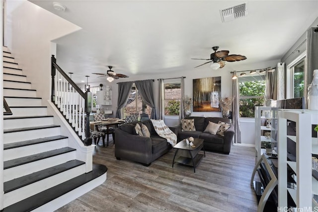 living room with ceiling fan and dark hardwood / wood-style flooring