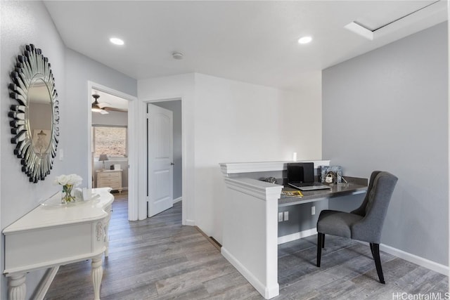 office space with hardwood / wood-style floors, built in desk, and ceiling fan