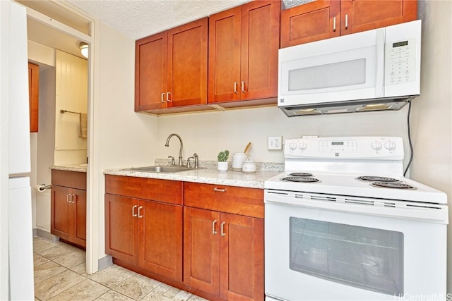 kitchen with light tile patterned flooring, a textured ceiling, white appliances, and sink