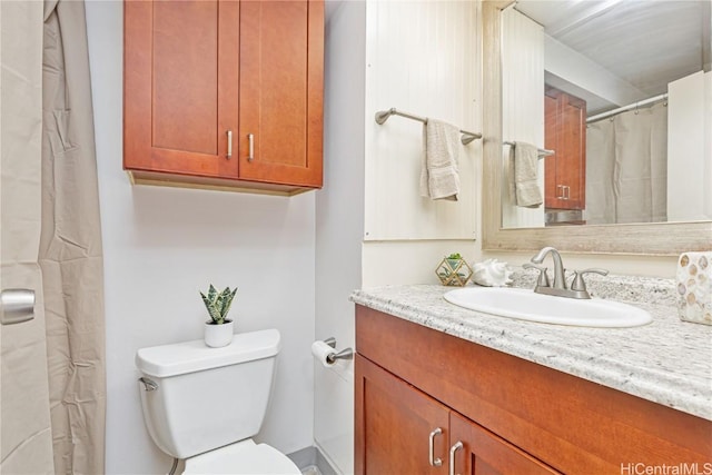 bathroom featuring vanity and toilet