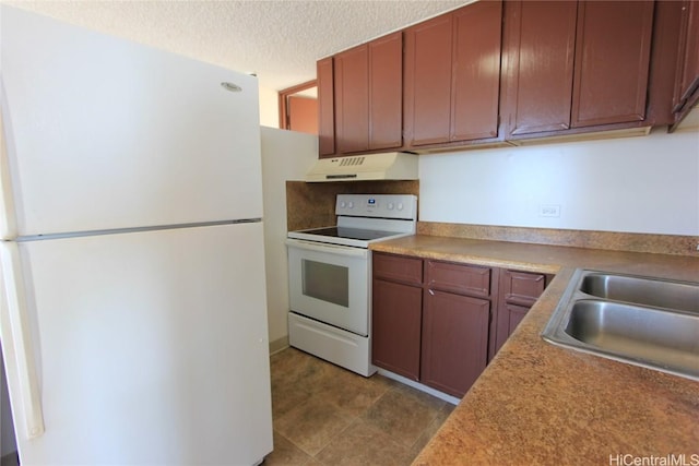 kitchen featuring a textured ceiling, white appliances, and sink