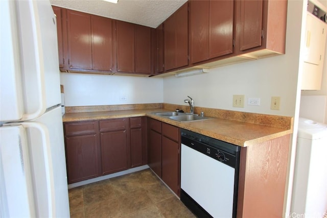 kitchen featuring sink, white appliances, and washer / dryer