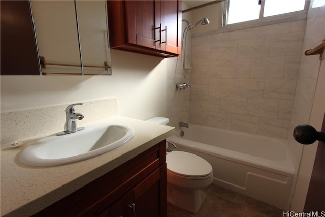 full bathroom featuring vanity, tiled shower / bath combo, and toilet