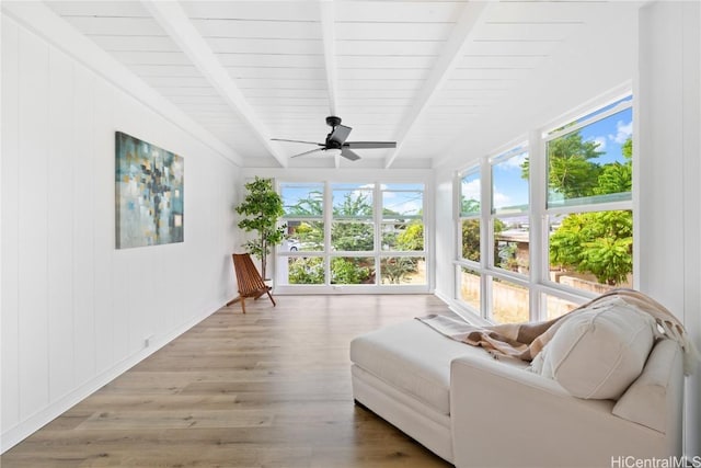 sunroom / solarium with ceiling fan, plenty of natural light, and beam ceiling