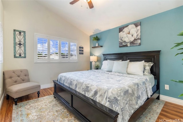 bedroom with baseboards, vaulted ceiling, and wood finished floors