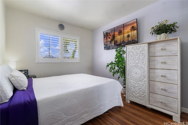 bedroom with dark wood-type flooring