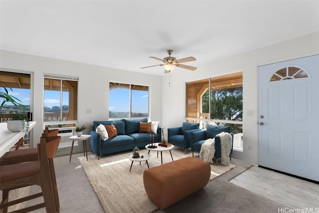 carpeted living room with ceiling fan