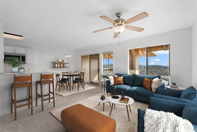 living room with ceiling fan and light colored carpet