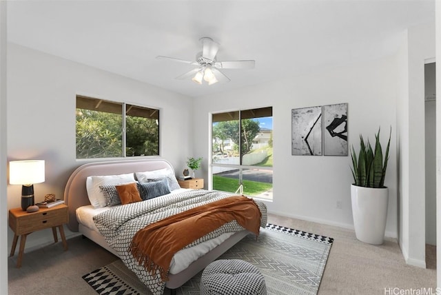 carpeted bedroom with multiple windows and ceiling fan