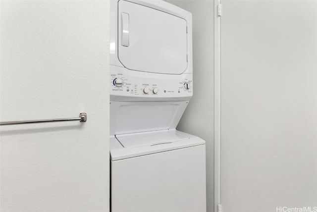 washroom featuring stacked washer / dryer