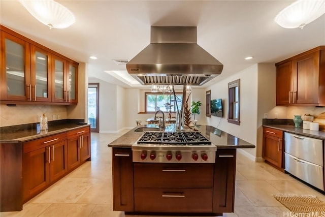 kitchen featuring pendant lighting, extractor fan, stainless steel gas stovetop, and sink