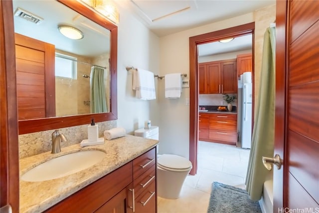 bathroom with toilet, a shower with curtain, vanity, and tile patterned floors