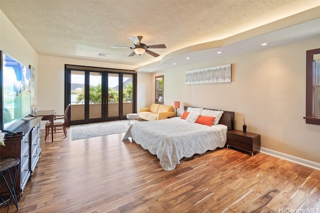 bedroom featuring access to exterior, ceiling fan, french doors, and hardwood / wood-style flooring