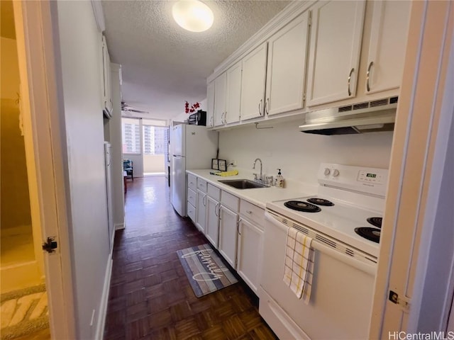 kitchen featuring sink, white appliances, dark parquet flooring, a textured ceiling, and white cabinets