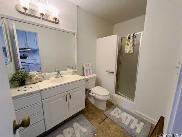 bathroom with a shower with door, vanity, tile patterned floors, and toilet