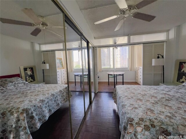 bedroom with dark parquet flooring and ceiling fan