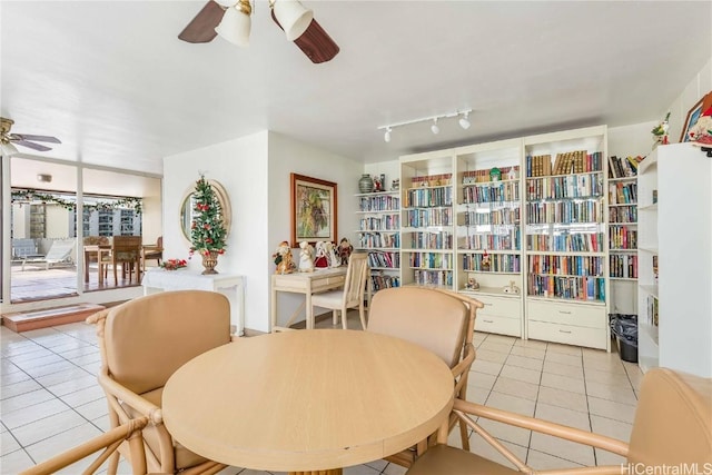 tiled dining space with ceiling fan