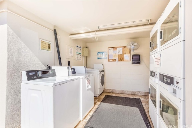 common laundry area featuring stacked washer and dryer, independent washer and dryer, and light tile patterned floors