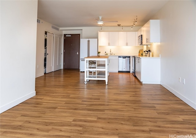 kitchen featuring ceiling fan, white cabinets, light wood-type flooring, and appliances with stainless steel finishes