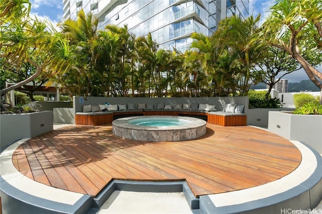 wooden terrace featuring an outdoor hot tub