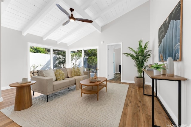 living room with wood-type flooring, high vaulted ceiling, plenty of natural light, and ceiling fan