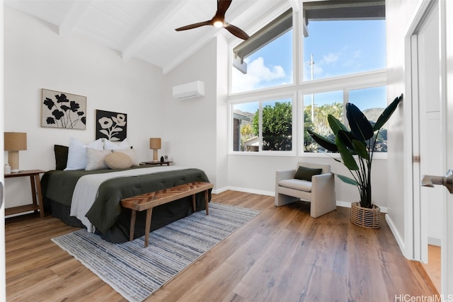 bedroom with lofted ceiling with beams, light hardwood / wood-style flooring, an AC wall unit, and ceiling fan