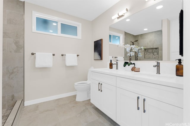 bathroom featuring vanity, toilet, and a tile shower