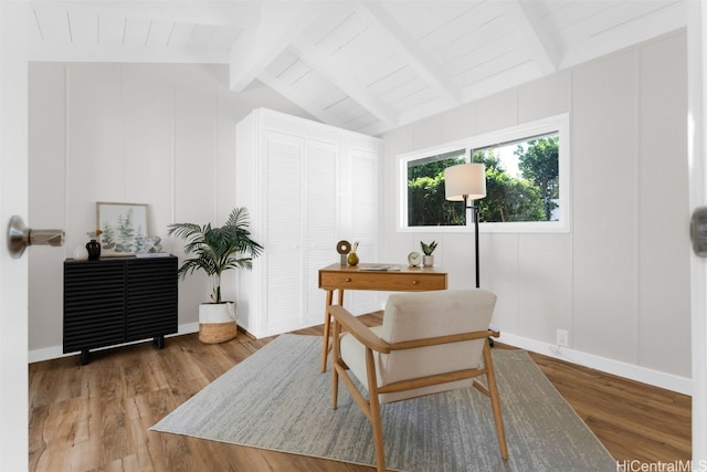 office area with hardwood / wood-style flooring and lofted ceiling with beams