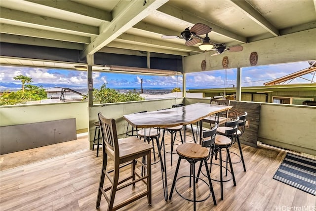 sunroom featuring ceiling fan