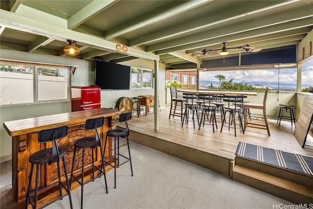 dining area featuring beam ceiling and ceiling fan