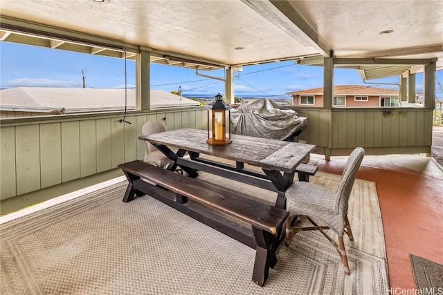 sunroom featuring beam ceiling