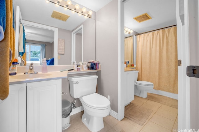 bathroom with tile patterned flooring, vanity, and toilet