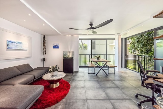 living room featuring a wealth of natural light and ceiling fan