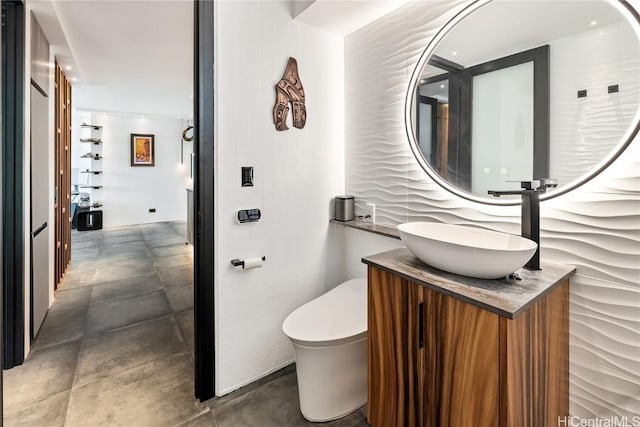 bathroom featuring vanity and toilet