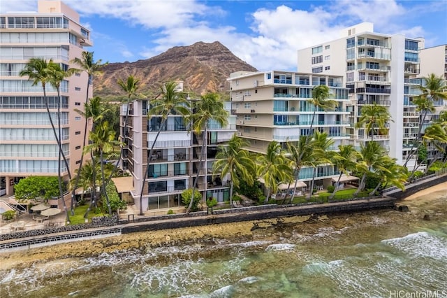 view of building exterior featuring a water and mountain view