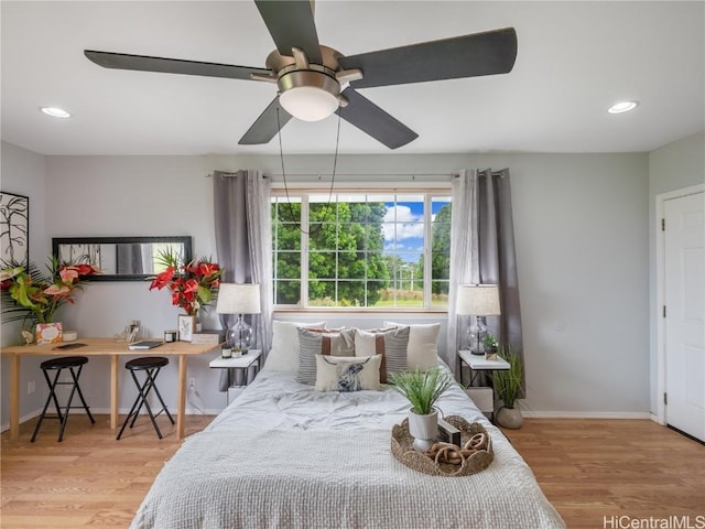 bedroom with light wood-type flooring and ceiling fan