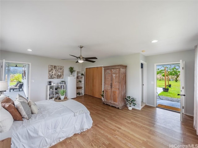 bedroom with multiple windows, access to outside, ceiling fan, and light hardwood / wood-style floors