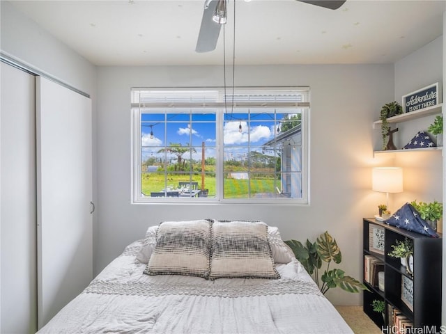 bedroom featuring ceiling fan and a closet