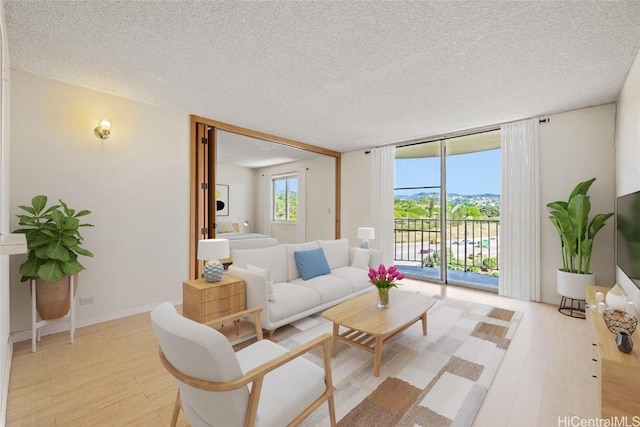 living room featuring expansive windows and a textured ceiling