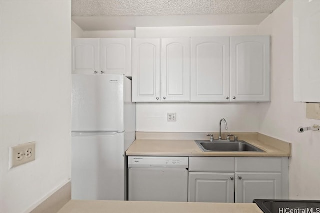 kitchen featuring a textured ceiling, white appliances, white cabinetry, and sink