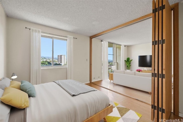 bedroom featuring wood-type flooring and a textured ceiling