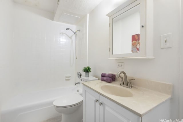 full bathroom featuring tiled shower / bath, vanity, a textured ceiling, and toilet