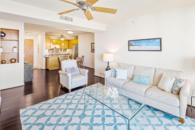 living room with dark hardwood / wood-style flooring and ceiling fan