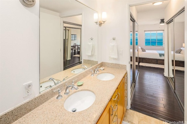 bathroom with vanity, hardwood / wood-style flooring, and ceiling fan