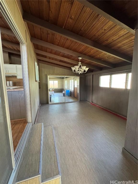 spare room featuring lofted ceiling with beams and wooden ceiling