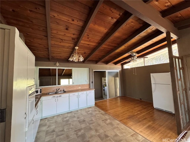 kitchen with white appliances, white cabinets, sink, lofted ceiling with beams, and wooden ceiling